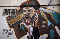 Two women take a selfie next to a newly painted graffiti of Hezbollah leader Hassan Nasrallah, Tel Aviv, Israel, September 29th 2024