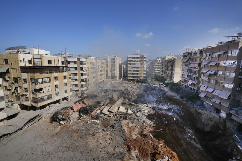 People gather at the site of the assassination of Hezbollah leader Hassan Nasrallah in Beirut's southern suburbs, Sunday, Sept. 29, 2024.