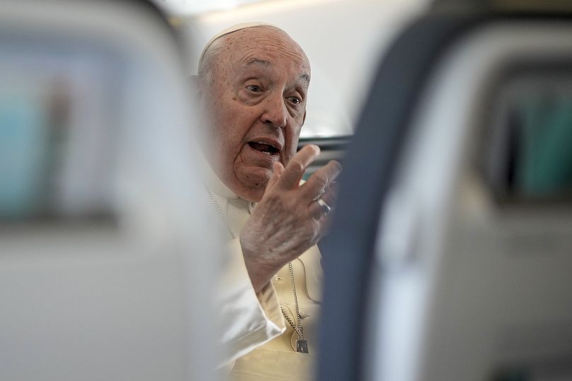 Pope Francis talks to journalists on the flight back to Rome at the end of his four-day visit to Belgium and Luxembourg, September 29, 2024