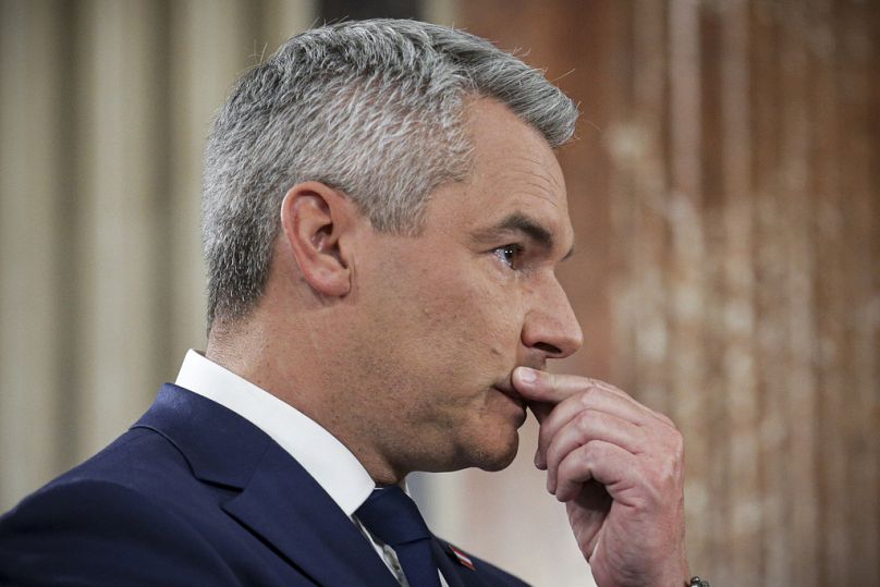 Austrian Chancellor Karl Nehammer gestures at the national broadcaster studio, set up in the parliament building, in Vienna, 29 September 2024