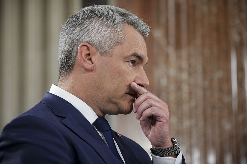 Austrian Chancellor Karl Nehammer gestures at the national broadcaster studio set up in the parliament building in Vienna, September 29, 2024