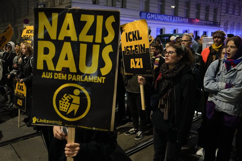 Protesters shout slogans and hold banners that read 'Nazis Out of Parliament’ outside the parliament building in Vienna, September 29, 2024