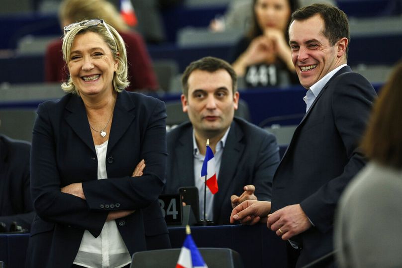 Marine Le Pen, left, Florian Philippot, center, and Nicolas Bay attend the session to elect the European Parliament president in Strasbourg, eastern France, Jan. 17 2017 