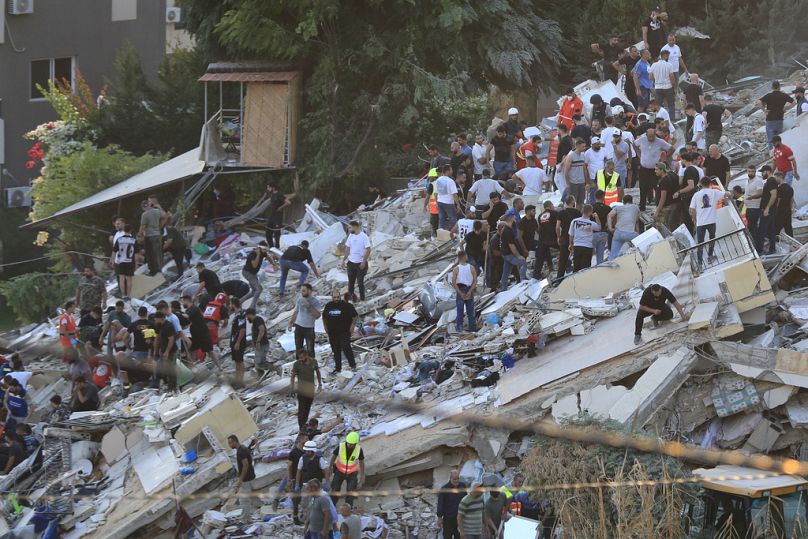 People and rescue workers in the Ain el-Delb neighbourhood east of the southern port city of Sidon, Lebanon, Sunday, Sept. 29, 2024.