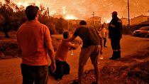 A resident reacts as a wildfire approaches the village of Ano Loutro as fanned by strong winds raged, 29 September 2024. A resident reacts as a wildfire approaches the village of Ano Loutro as fanned by strong winds raged, 29 September 2024.