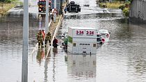 Firefighters work at a flooded road in Copenhagen, Sunday, Aug. 4, 2024. Firefighters work at a flooded road in Copenhagen, Sunday, Aug. 4, 2024.