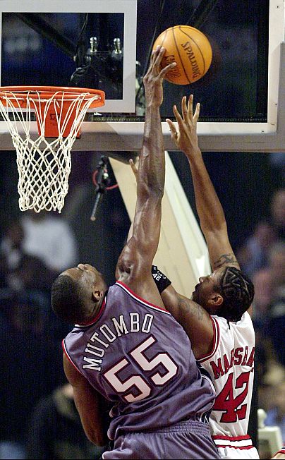 New Jersey Nets' Dikembe Mutombo (55) blocks a layup by Chicago Bulls' Donyell Marshall during the first quarter Saturday, Nov. 9, 2002, in Chicago.