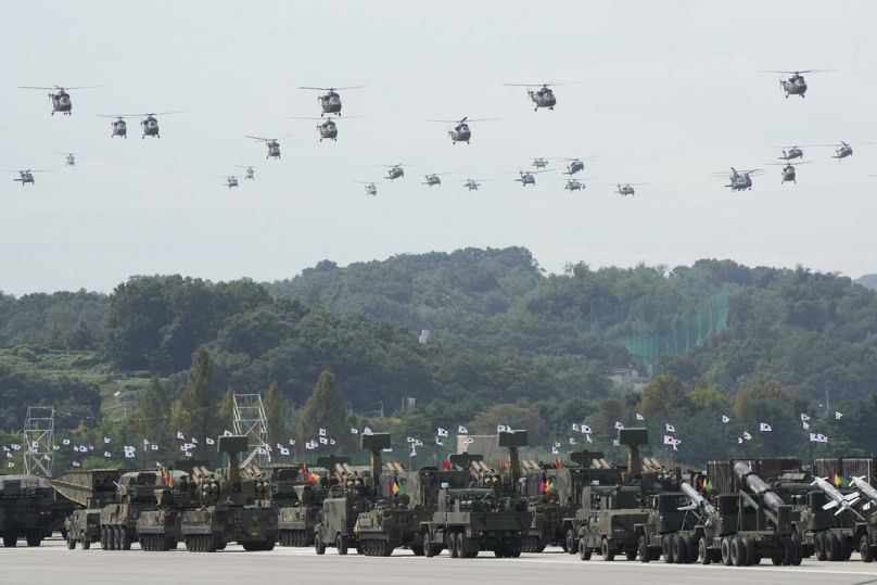 South Korean military helicopters fly over armoured vehicles during the media day for the 76th anniversary of Armed Forces Day at Seoul air base in Seongnam, Sept. 25, 2024