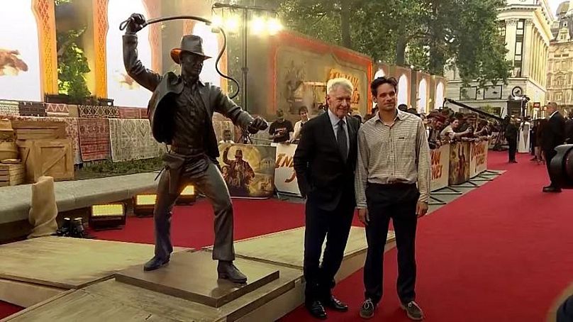 Harrison Ford poses with sculptor Fred Tucker next to the Indiana Jones statue - London, 28 June 2023