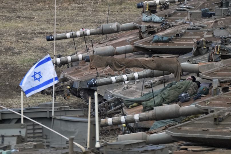 Israeli soldiers sleep on tanks in a staging area in northern Israel near the Israel-Lebanon border.