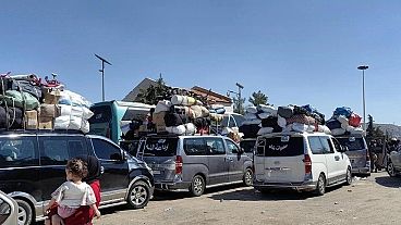 Families fleeing Israeli airstrikes in Lebanon arrive at the Syrian border on Tuesday. Families fleeing Israeli airstrikes in Lebanon arrive at the Syrian border on Tuesday.