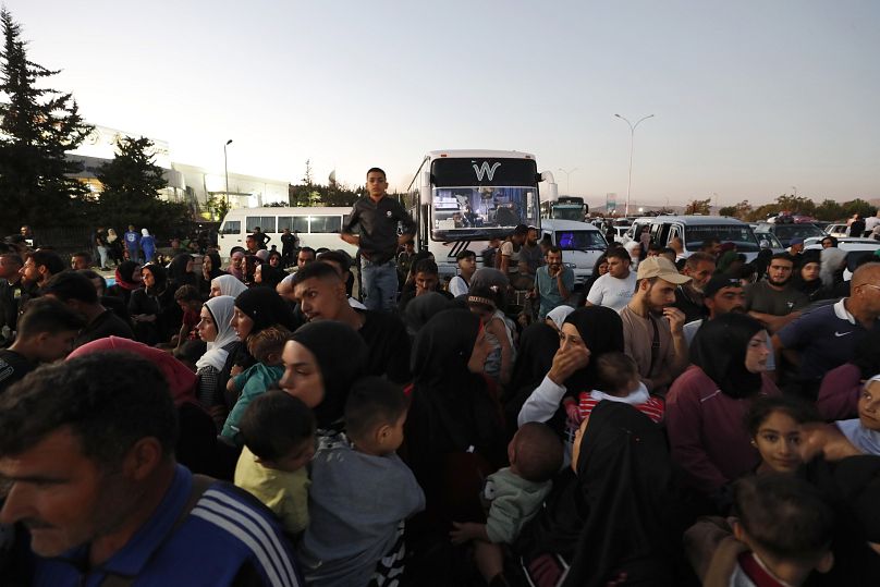 Syrians fleeing the war in Lebanon, arrive at the Syrian-Lebanese border crossing in Jdeidet Yabous, Syria.