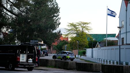 A police vehicle is seen near the Israeli embassy in Copenhagen as officers investigate two explosions in the area.