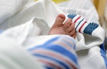 A newborn's foot is shown in hospital.