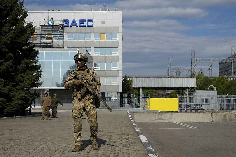 A Russian serviceman stands guard in an area of the Zaporizhzhia Nuclear Power Station in territory under Russian military control, May 1, 2022