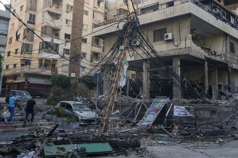 People check the site of an Israeli airstrike in Dahiyeh, Beirut, Lebanon, Sunday, Oct. 6, 2024.
