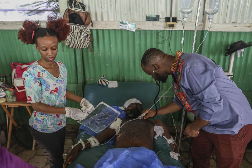 Medical staff attend to a man who sustained gunshot wounds during violent gang attacks.