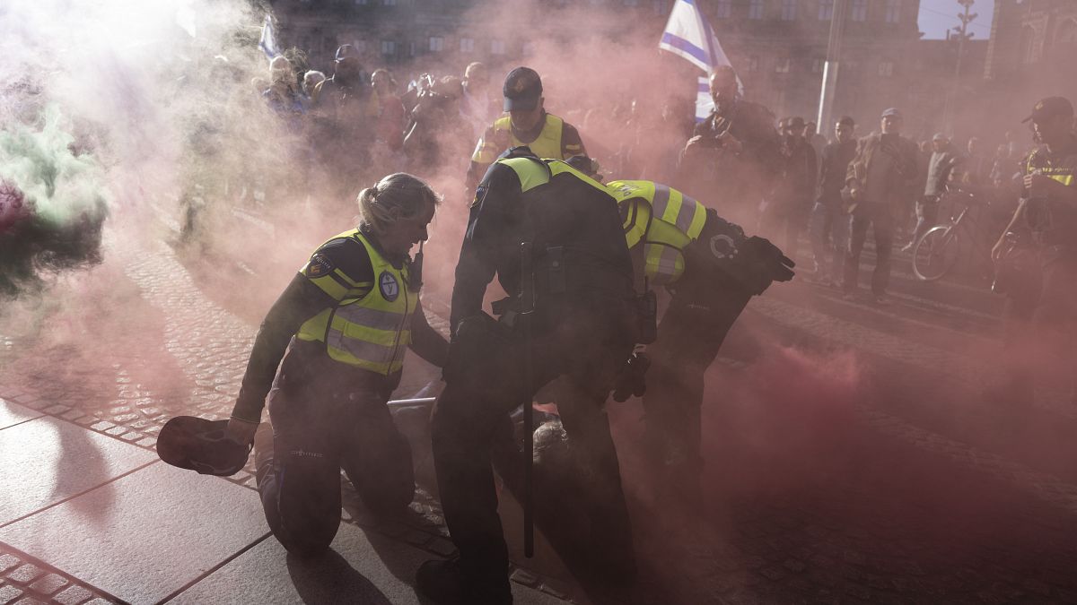 Police and Palestinian supporters clash in Amsterdam during 7 October commemorations