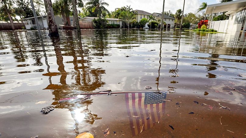 An American flag sits in floodwaters in the aftermath of Hurricane Helene in the Shore Acres neighbourhood, 27 September 2024, in St. Petersburg, Fla.