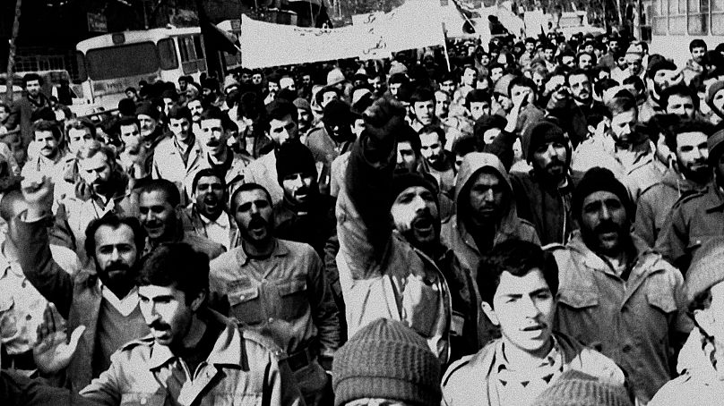 Iranians demonstrate on a Tehran street, Feb. 15, 1989, chanting slogans "Down with Britain and down with America," to protest the publishing in the UK of 'The Satanic Verses'