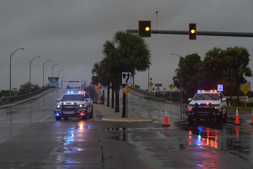 Police block off a bridge leading to the barrier island of St. Pete Beach, Fla., ahead of the arrival of Hurricane Milton, in South Pasadena, Fla., Wednesday, Oct. 9, 2024.