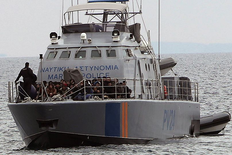 Migrants aboard a Cyprus marine police patrol boat as they're brought to a harbour after being rescued,