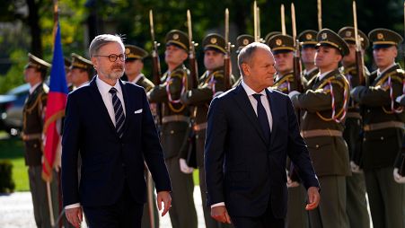 Czech Republic's Prime Minister Petr Fiala, left, welcomes his Poland's counterpart Donald Tusk as they meet in Prague, Czech Republic, Wednesday, Oct. 9, 2024.
