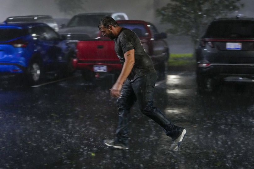 Chris Nation, of Commerce, Ga., skids on puddles in the parking lot of the hotel where he's ...