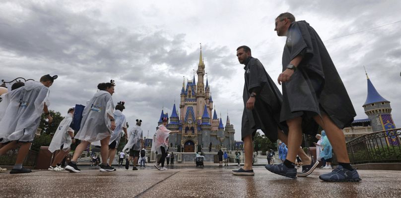 Guests weather early bands of rain from Hurricane Milton at the Magic Kingdom at Walt Disney World ahead of the park's closure