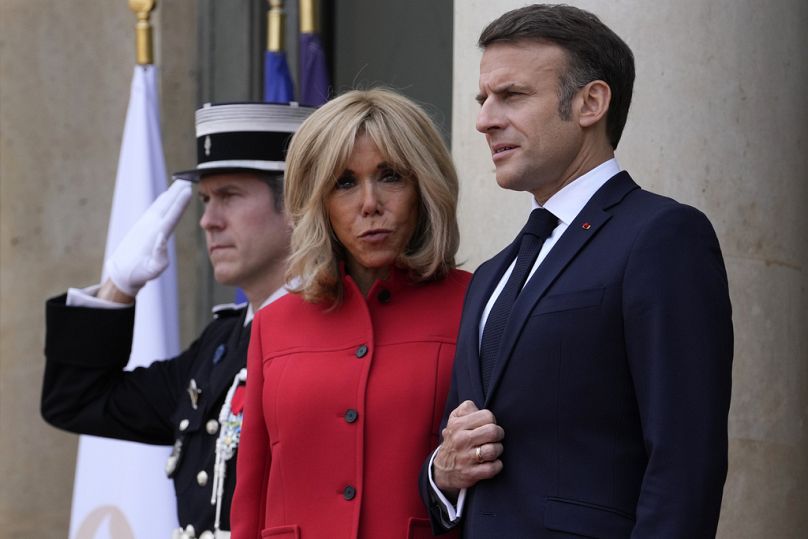 FILE - French President Emmanuel Macron and his wife Brigitte Macron wait for China's President Xi Jinping and his wife Peng Liyuan at the Elysee Palace, Monday, May 6, 2024 i