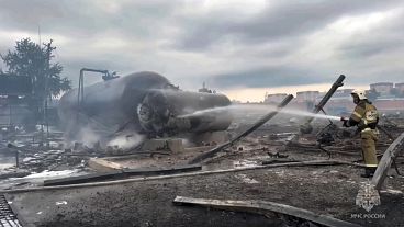 Firefighters extinguish a large fire after an explosion at a petrol station in Grozny, 12 October, 2024
