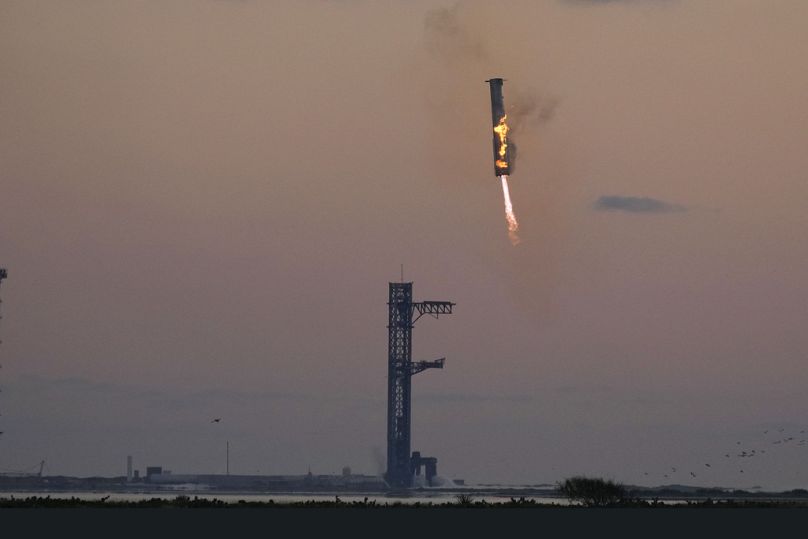 SpaceX's mega rocket booster returns to the launch pad to be captured during a test flight Sunday, Oct. 13, 2024, in Boca Chica,, Texas. 