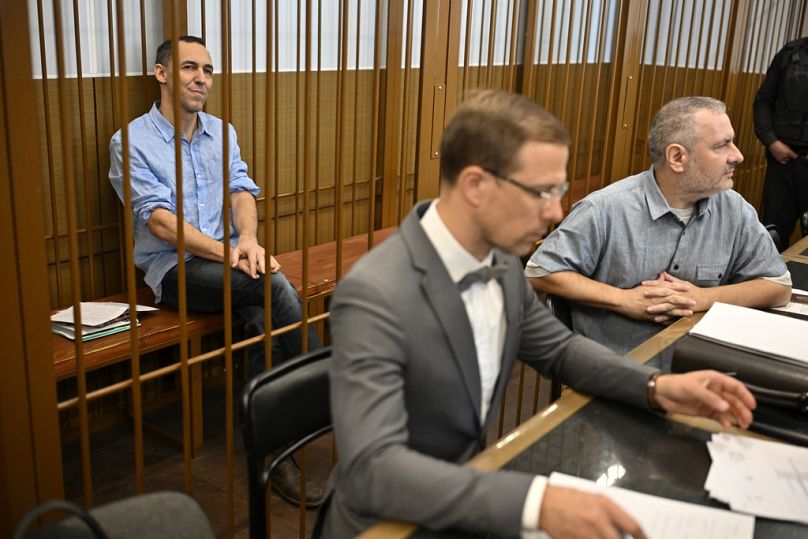 French citizen Laurent Vinatier sits in a cage behind his lawyers at the Zamoskvoretsky District Court in Moscow, Russia, Monday, Sept. 16, 2024. 