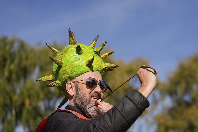 Competitor Neil Morbey wearing a conker themed hat takes part in the annual World Conker Championships - 13 October 2024