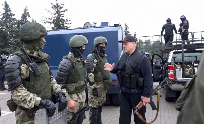 Belarus President Alexander Lukashenko greets riot police near the Palace of Independence in Minsk, 23 August 2020