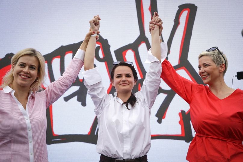 Activist Maria Kolesnikova, presidential candidate Sviatlana Tsikhanouskaya and Veronkika Tsepkala gesture at a rally in Minsk, 19 July 2020