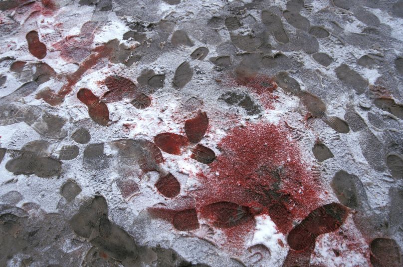 Blood and footprints in the snow following a Russian attack that killed a civilian driver in Chechnya in December 1994.