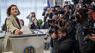 Moldova's President Maia Sandu prepares to cast her vote, in Chisinau, Moldova, Sunday, Oct. 20, 2024,