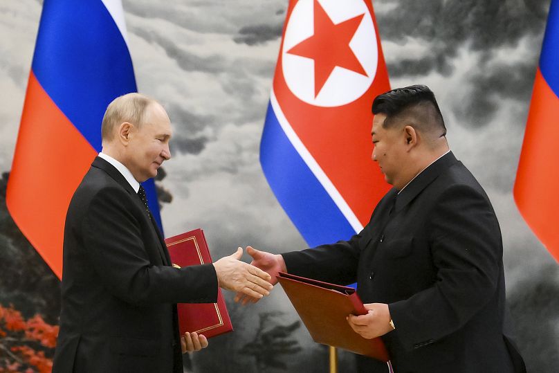 Russian President Vladimir Putin, left, and North Korea's leader Kim Jong Un exchange documents during a signing ceremony in Pyongyang, 19 June, 2024