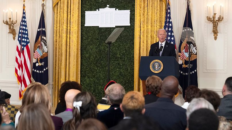 President Joe Biden speaks during a National Arts and Humanities Reception in the East Room at the White House in Washington