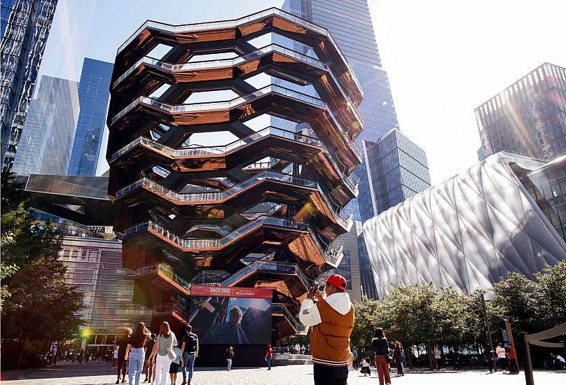 A man takes a picture as the Vessel reopens with safety features in New York, Monday, 21 October 2024.