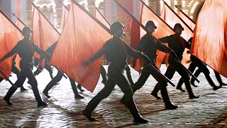 FILE: Russian soldiers with Soviet Army Red flags march during a rehearsal for the Victory Day military parade at the Moscow Red Square, 4 May 2010