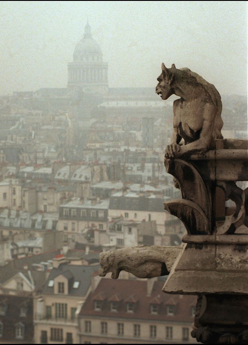 A gargoyle watches over Paris from the top of the 11th century Notre Dame cathedral Friday Jan 10, 1997. 