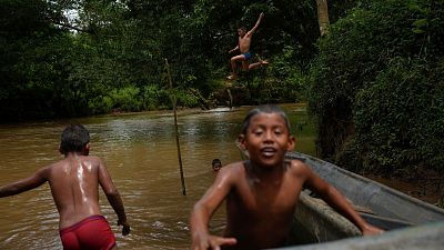 Children in El Jobo village play in the Indio River, which could have its flow reduced under a proposed plan to secure the Panama Canal, August 31, 2024. 