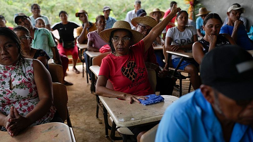 Jeronima Figueroa raises her hand during a meeting with Panama Canal representatives about a proposed project that would dam the Indio RiverAug. 31, 2024.