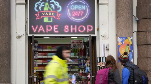 Pedestrians pass a vape shop in London, Monday, January 29, 2024.