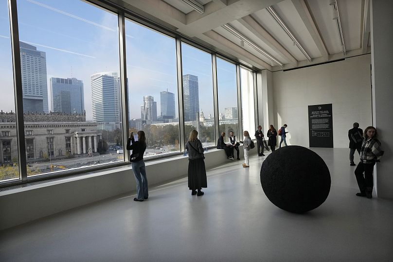 People look out of the window of the Museum of Modern Art in Warsaw, Poland, on Thursday Oct. 24, 2024