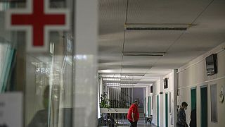 People walk in a corridor at the state hospital in Bulgaria in 2021. 