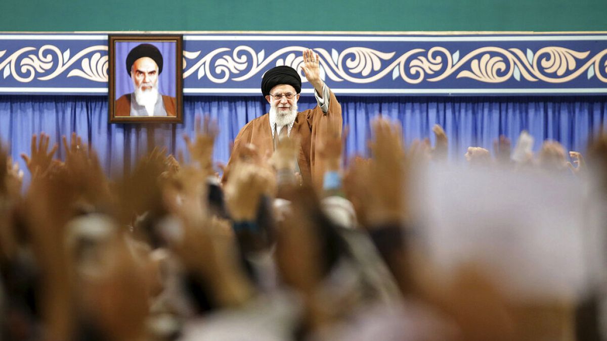 FILE - Supreme Leader Ayatollah Ali Khamenei waves to members of the Revolutionary Guard's all-volunteer Basij force in a meeting in Tehran, Iran, November 2019