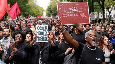 People carry signs with the name of Odair Moniz, a Black man of Cape Verdean origin who was fatally shot by police Monday, during a protest against racism and police violence. People carry signs with the name of Odair Moniz, a Black man of Cape Verdean origin who was fatally shot by police Monday, during a protest against racism and police violence.